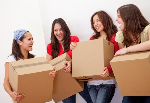 Moving specialists organizing boxes and furniture for a Holland Park relocation