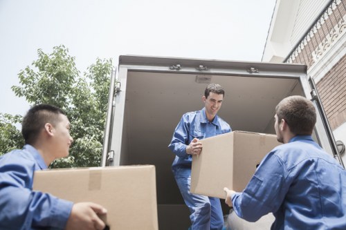 Man with van loading furniture in a Holland Park street