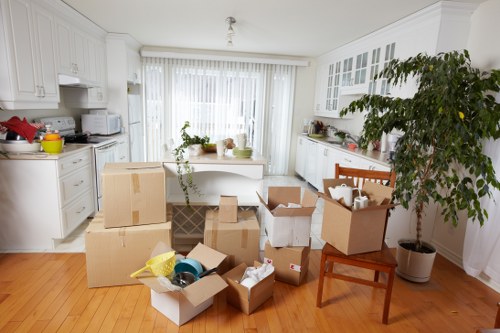 Local removals van loading items near a Holland Park property