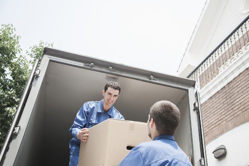 Van moving household items through a West London street
