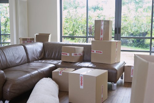 Professional movers handling furniture near Holland Park properties